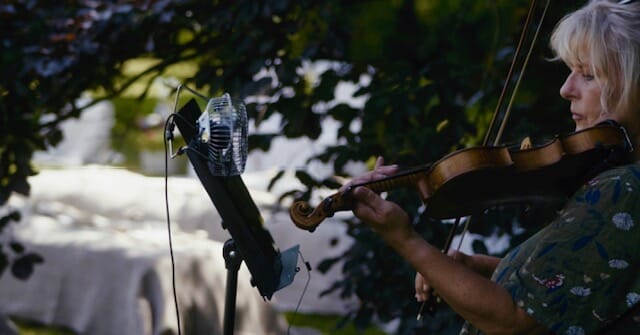 A violinist plays in the grounds of Solton Manor during a wedding ceremony