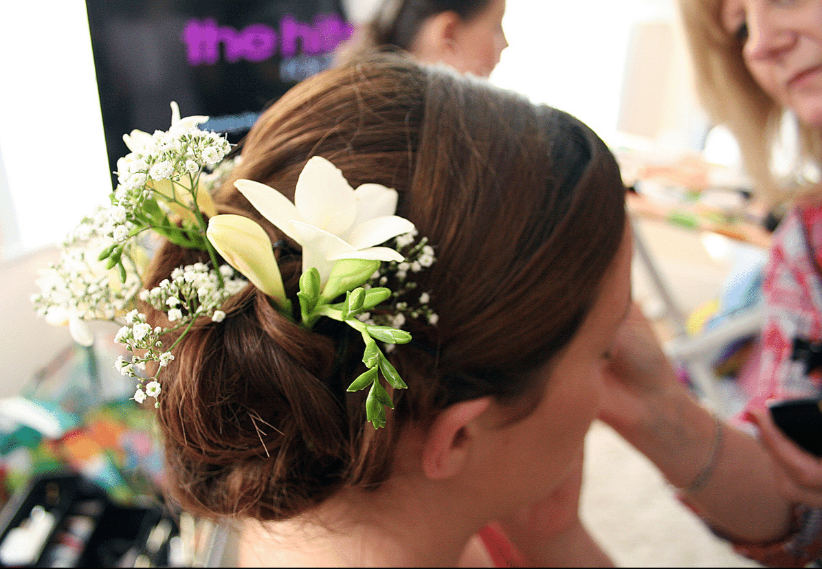 A bride with fresh Lilies in her hair at Solton Manor, near Dover, Kent, England