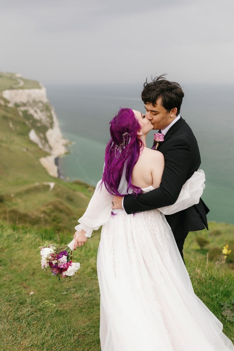 A couple stand an kiss on top of the White Cliffes of Dover near to Solton Manor in Kent
