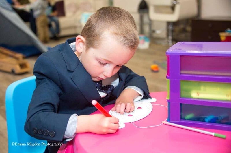 A small child being entertained at Solton Manor while the bridal party get ready for a wedding