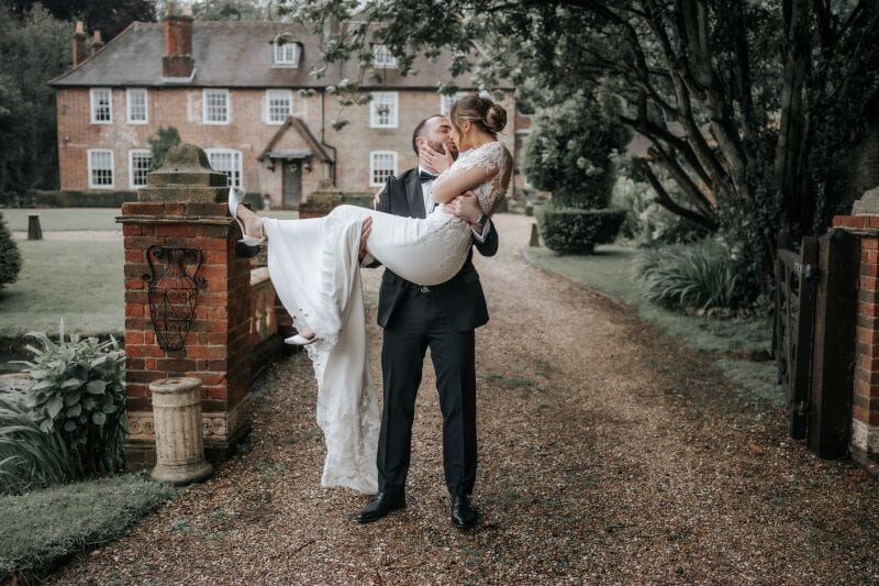 A couple enjoy a kiss on the Ponte Vecchio Bridge over the moat at Solton Manor in near Canterbury in Kent