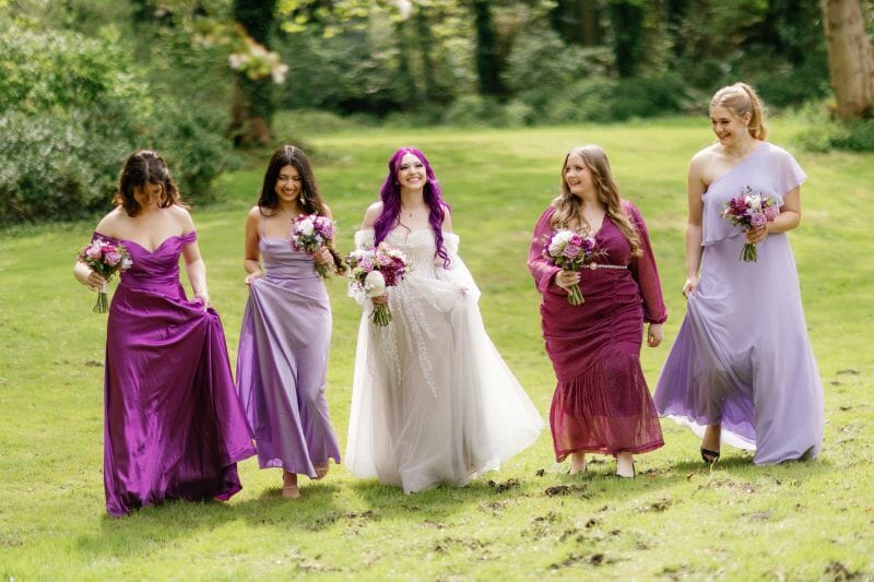 The bride, Kaitlyn from America, walks with her Bridal Party in the grounds of Solton Manor in Kent with her bridal party