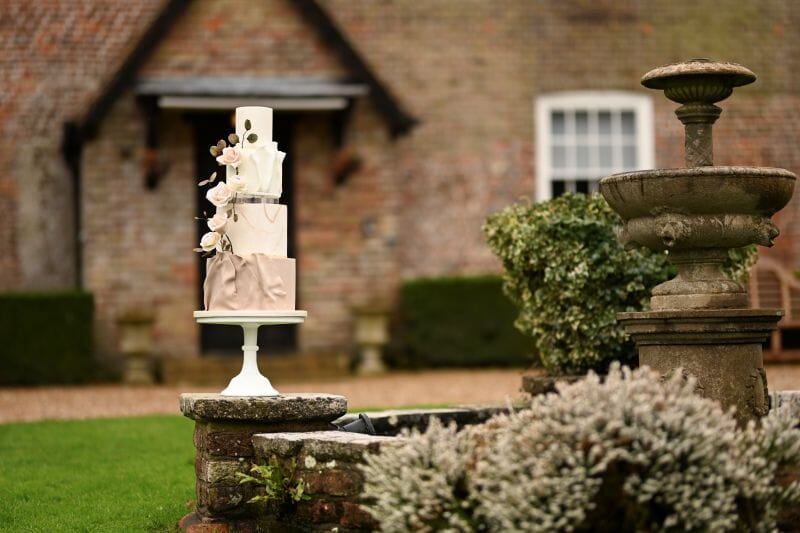 A Pretty Prep four tier Wedding Cake sat on the fountain in front of Solton Manor House, near Dover, Kent, England
