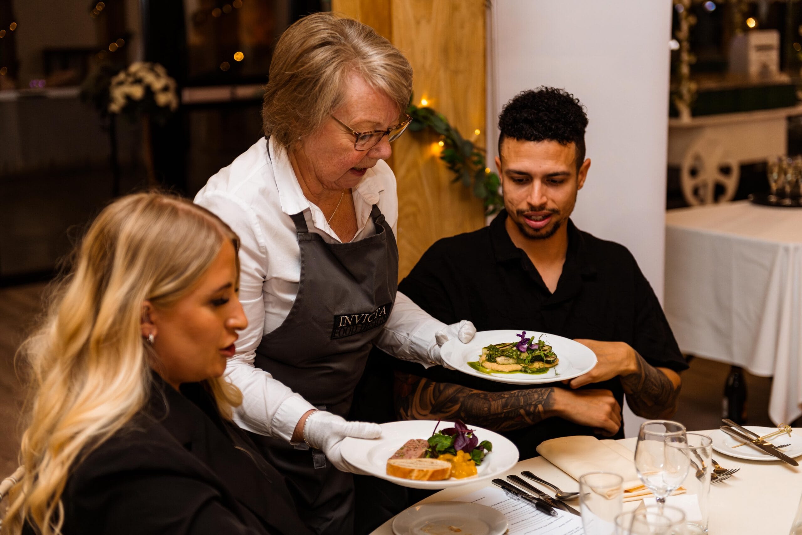 A member of staff holds two plates of starters during a Tasting Evening at Solton Manor, East Langdon, Dover, Kent, England