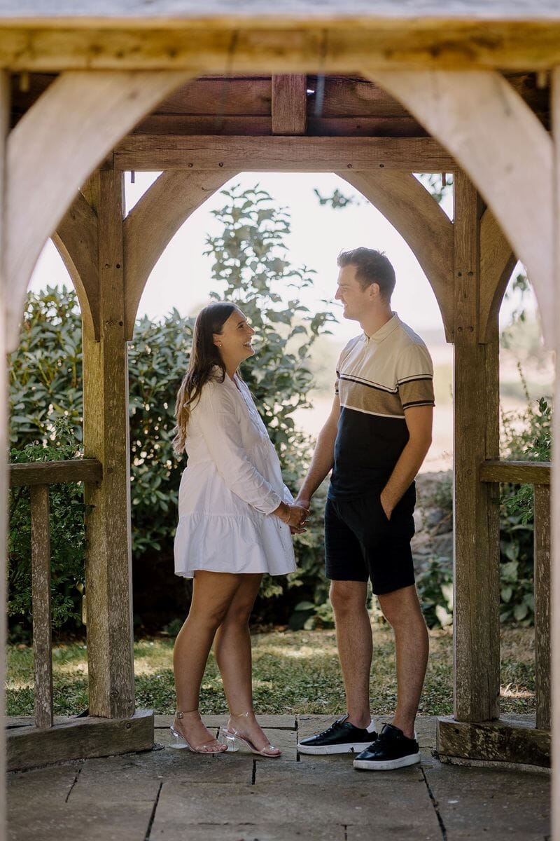 A just engaged couple in Godric's garden at Solton Manor, Dover, Kent, England