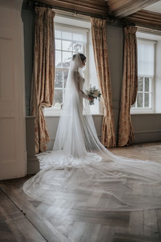 A bride stands in the Great Hall of Solton Manor near Sandwich, Kent, England