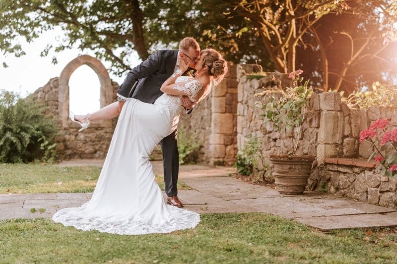 A couple enjoying a drop kiss in the ruins of Solton Manor, near Walmer, Kent, England