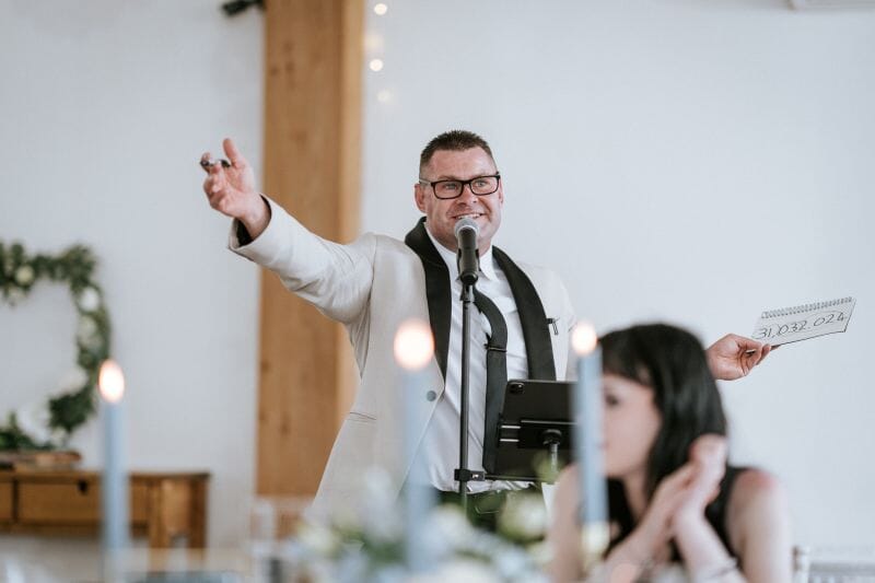 A magician, Matty Evans, entertains the wedding guests in the Dutch Barn at Solton Manor, Kent, England