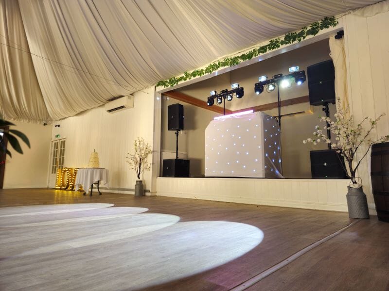 DJC (DJ Colin) set up on the stage at Solton Manor, in the Dutch Barn, Kent