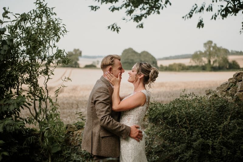 A couple stand in the ruins at Solton Manor, over looking the Kentish fields out to Walmer, Kent, England, UK