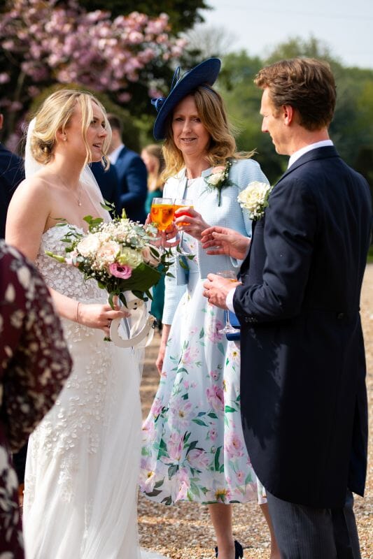 Wedding couple at Solton Manor with a romantic cherry blossom backdrop, a spring wedding at a historic country manor wedding venue in Kent