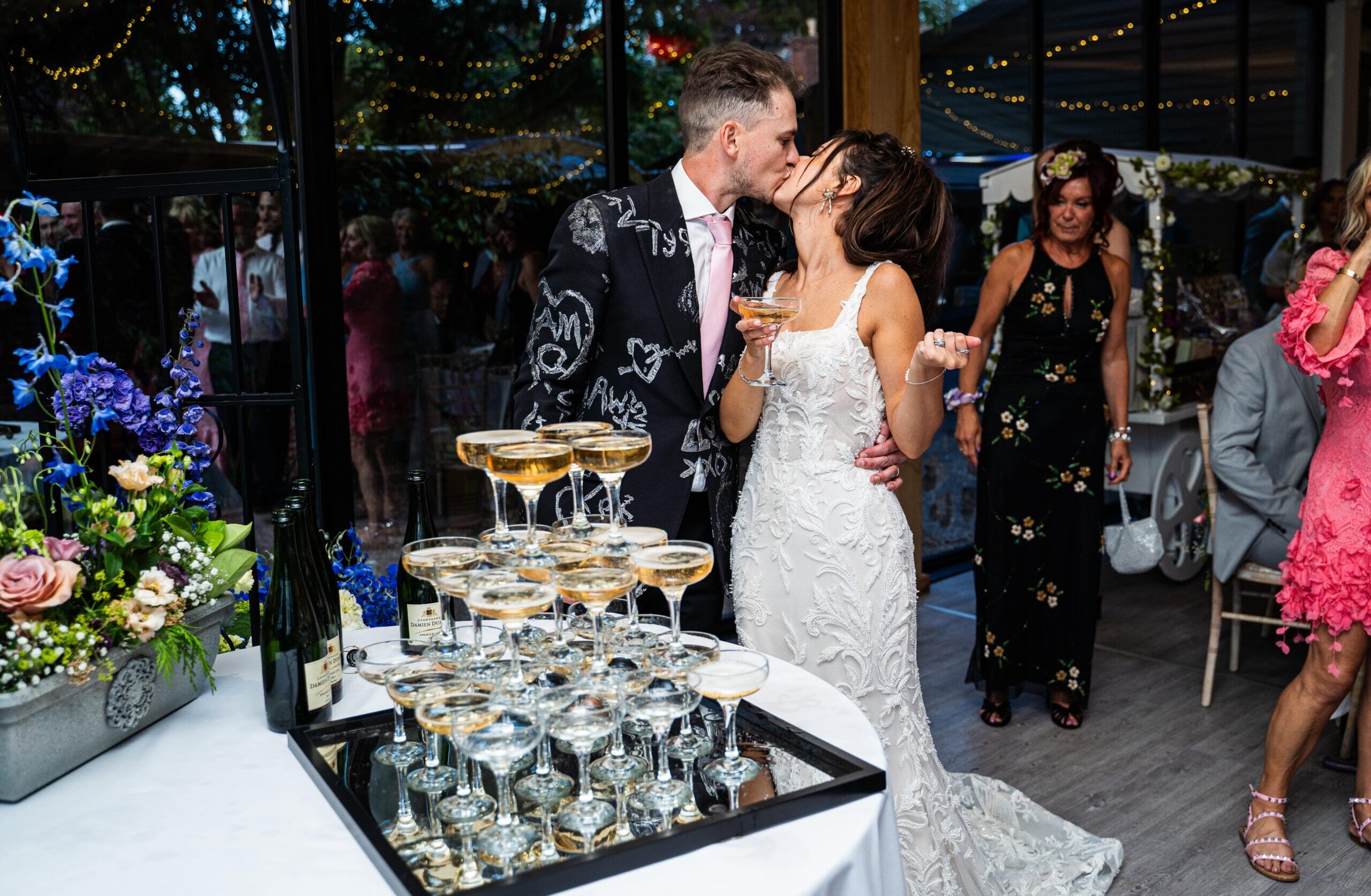 broom and bride kissing at Solton Manor