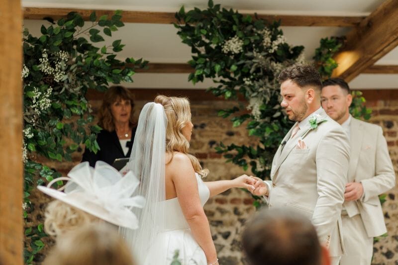 A just married couple stand in the Old Stables indoor ceremony room at Solton Manor Kent