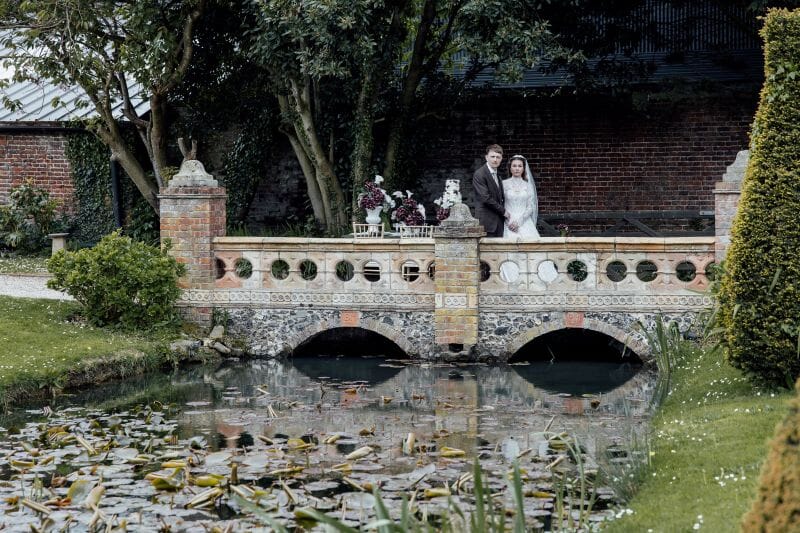 A couple stands next to a styled table, set up outside Solton Manor Country House on the Ponte Vecchio Bridge, Kent, England