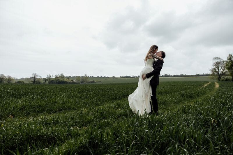 A just married couple stand in the field adjacent to Solton Manor, between Dover and Deal, Kent, England