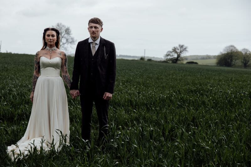 A just married couple stand in the field adjacent to Solton Manor, between Dover and Deal, Kent, England