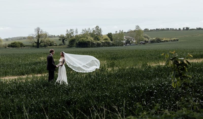 A just married couple stand in the field adjacent to Solton Manor, between Dover and Deal, Kent, England