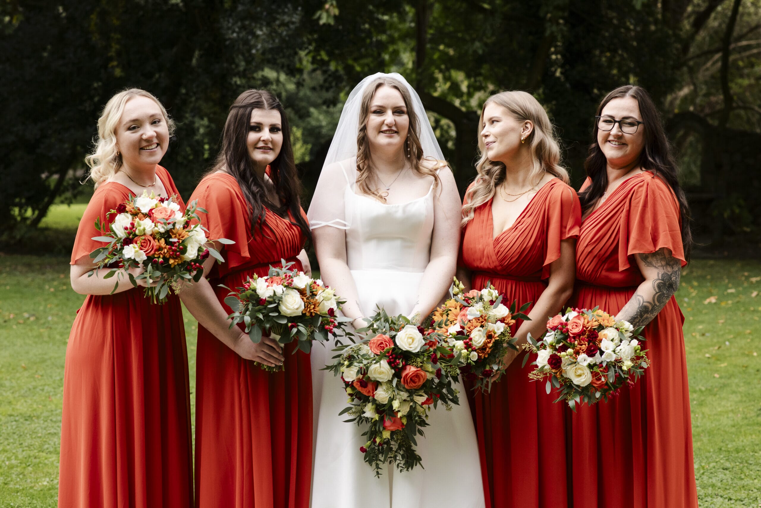An autumn wedding, where the bridesmaids are dressed in Autumnal orange, at Solton Manor, Wedding, Events and Stays venue between Dover and Deal.